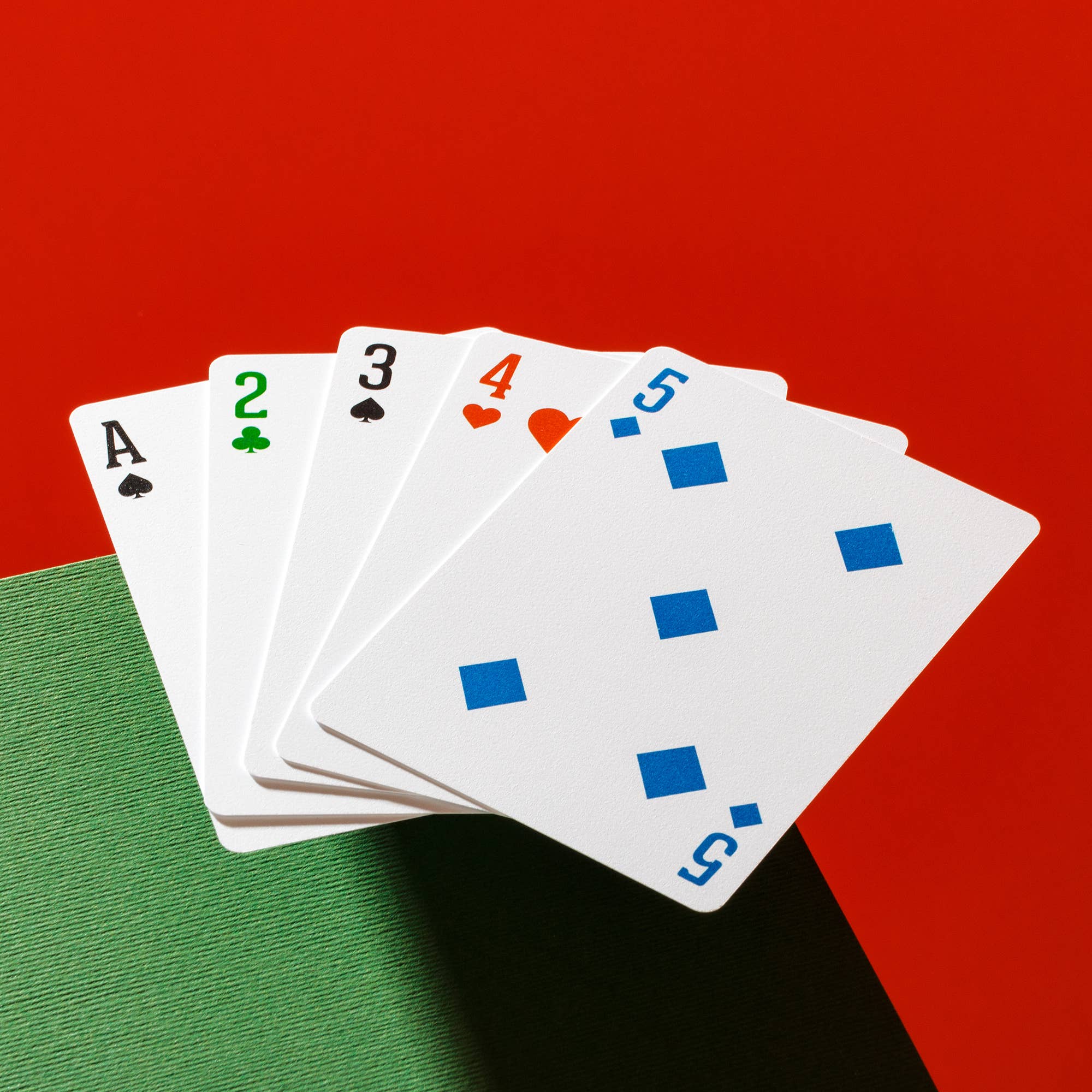 Four color playing cards featuring distinct suit colors for poker and bridge
