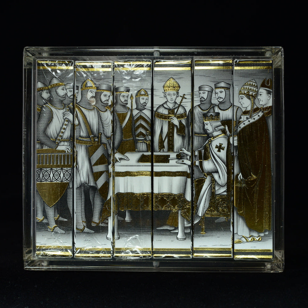 Front view of six collector playing card decks displayed together in a Carat X6 acrylic case