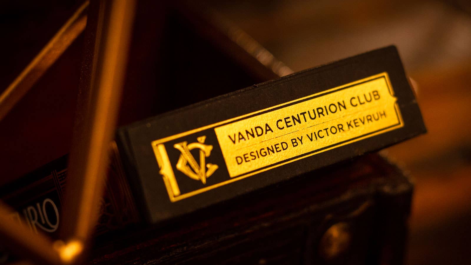 Vanda Centurion Club label designed by Victor Kevrum on a blurred background