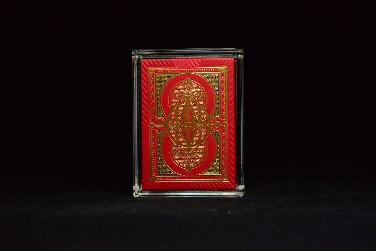Red and gold playing card box on a black background