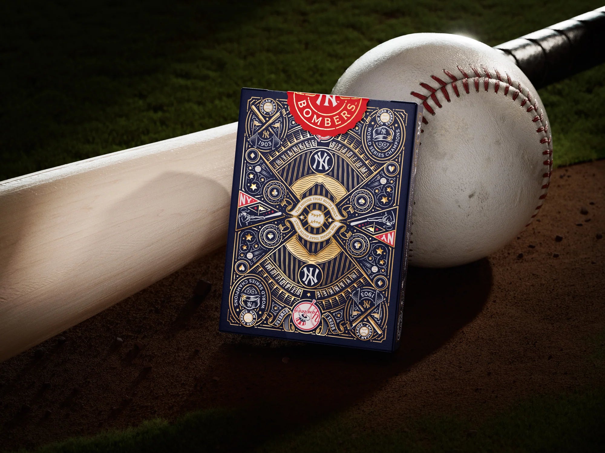 Back design of Theory11 New York Yankees playing card leaning against a baseball on the infield grass.