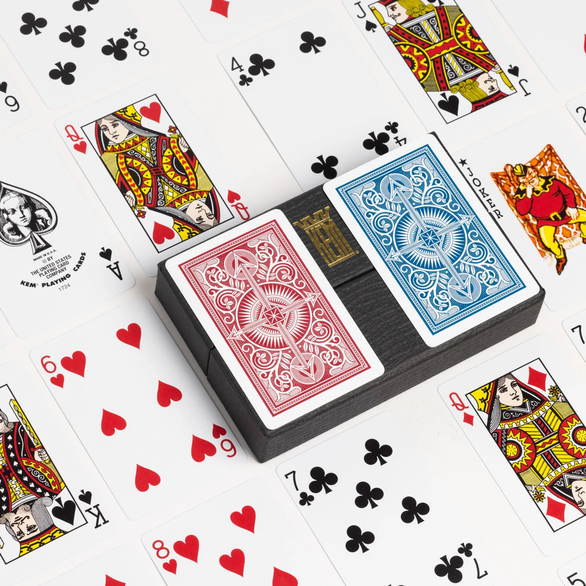 KEM playing cards with a focus on a deck of cards and various card faces.