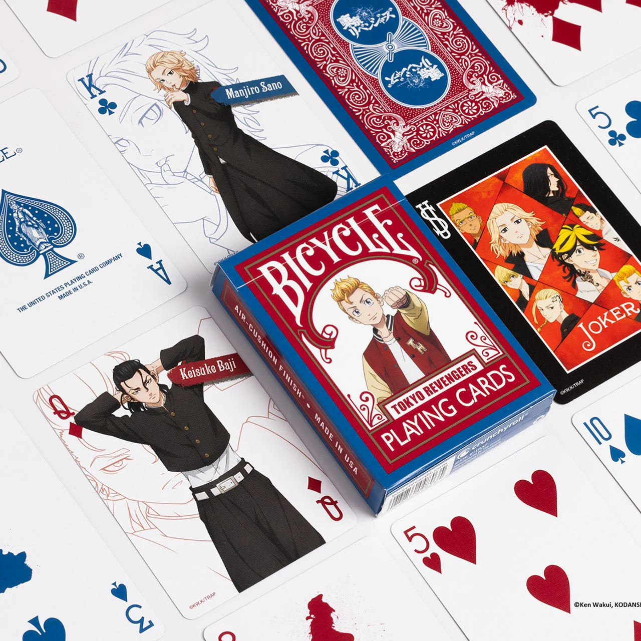 Bicycle Tokyo Revengers deck spread out with anime court cards, custom red backs, and tuck box in the center.