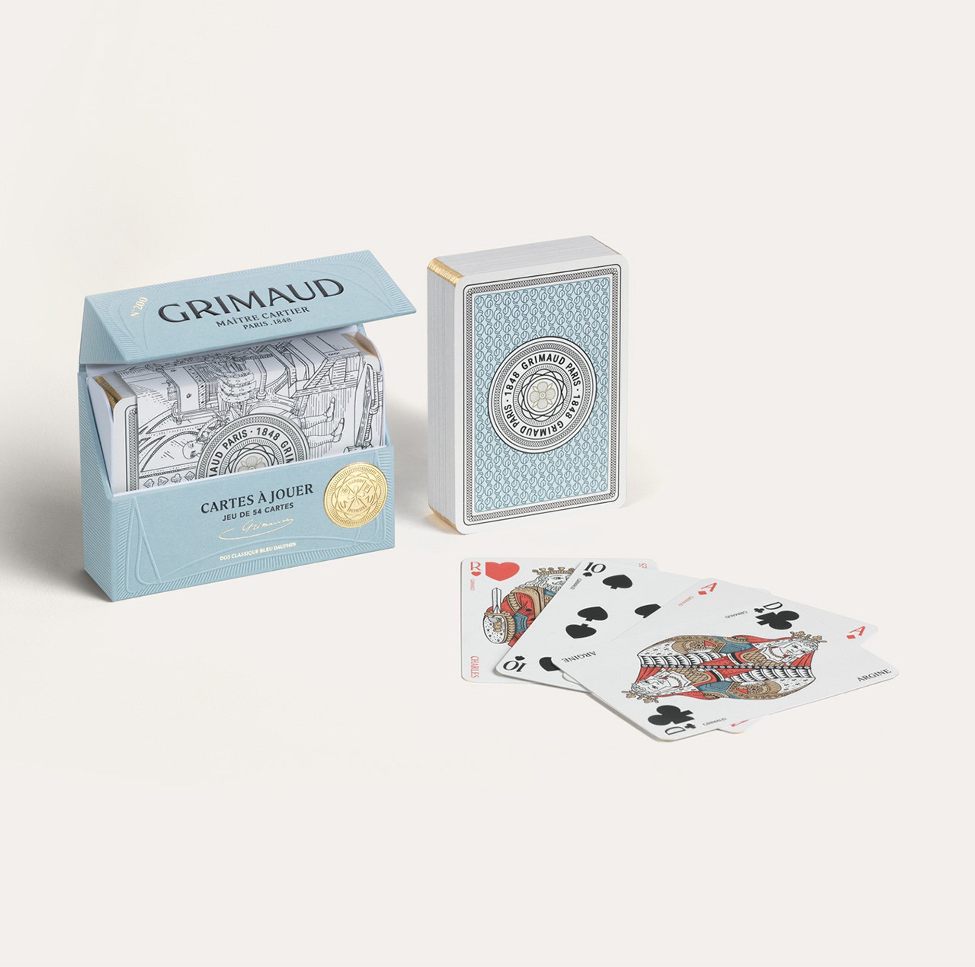 Grimaud dolphin blue playing cards with open box and cards displayed on a white background