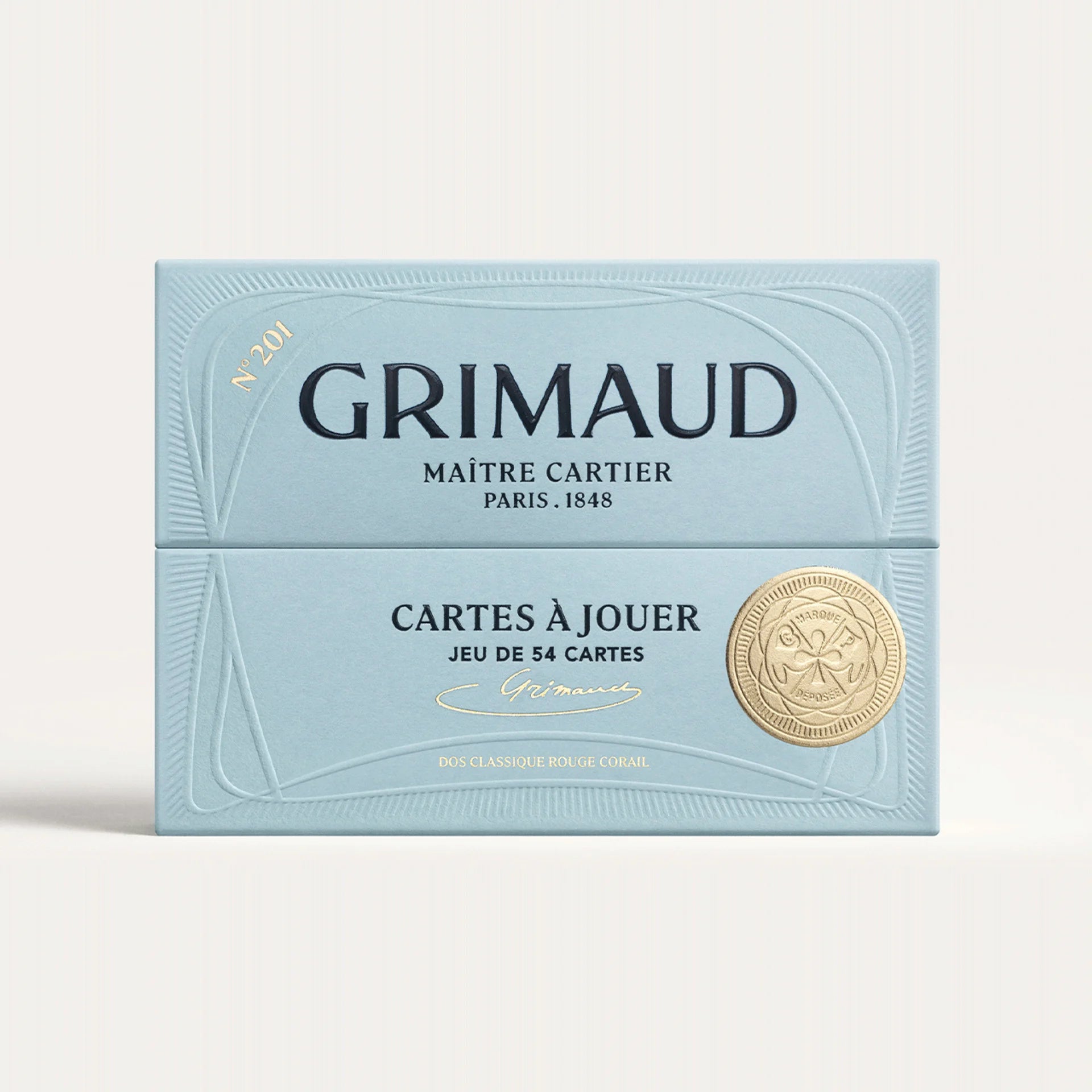 Grimaud playing card box with gold emblem on a white background