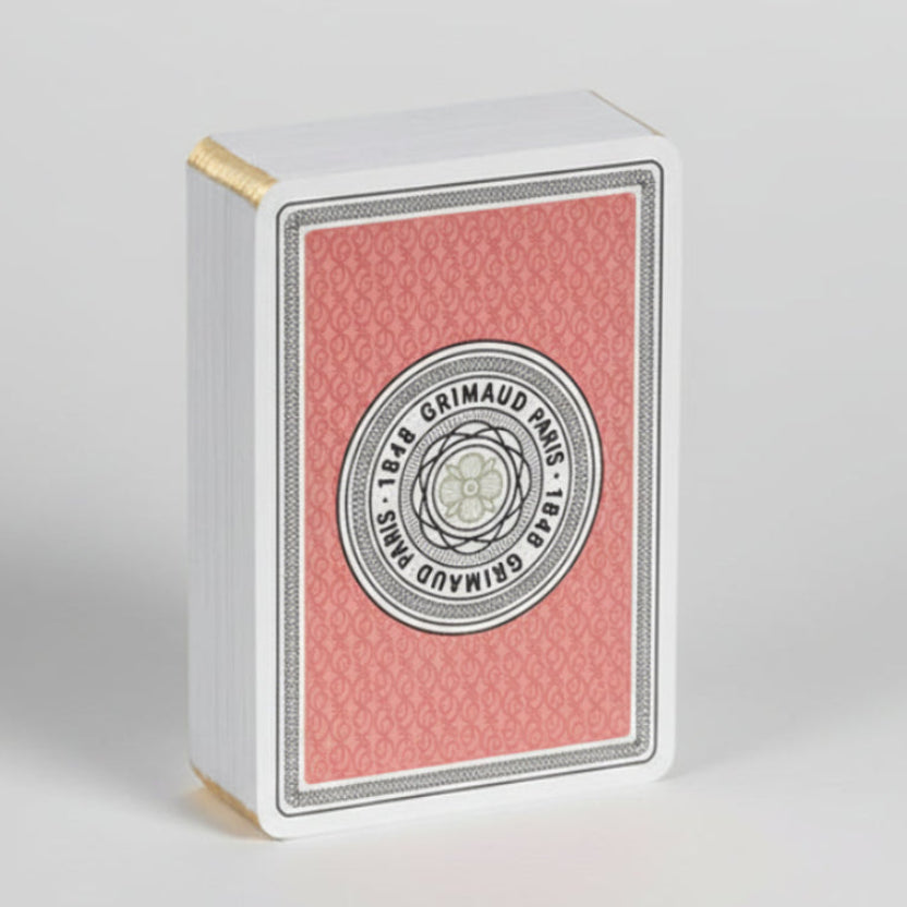 Grimaud N201 playing cards in coral red on a white background.