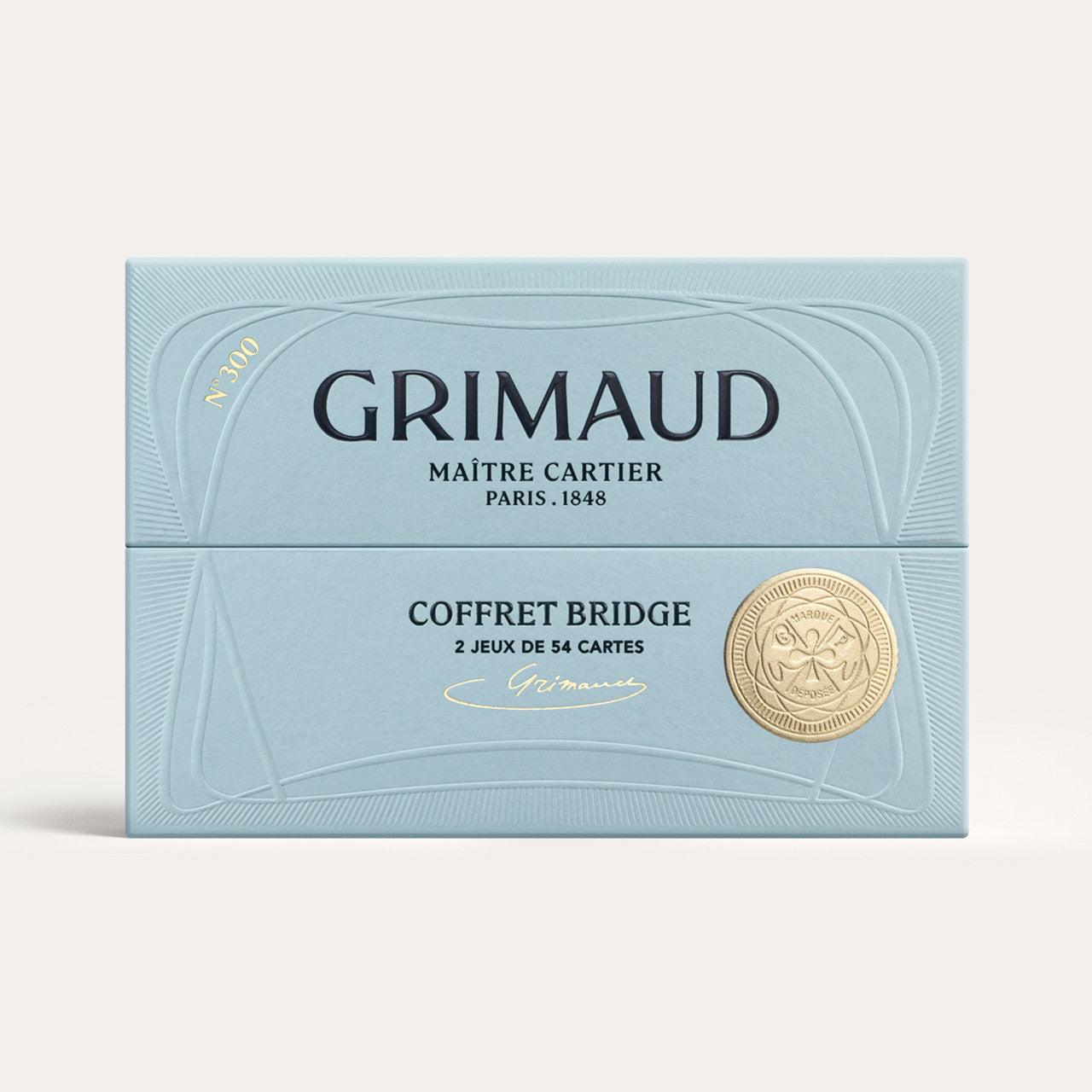 Grimaud N°300 Coffret Bridge box with gold emblem on a light blue background