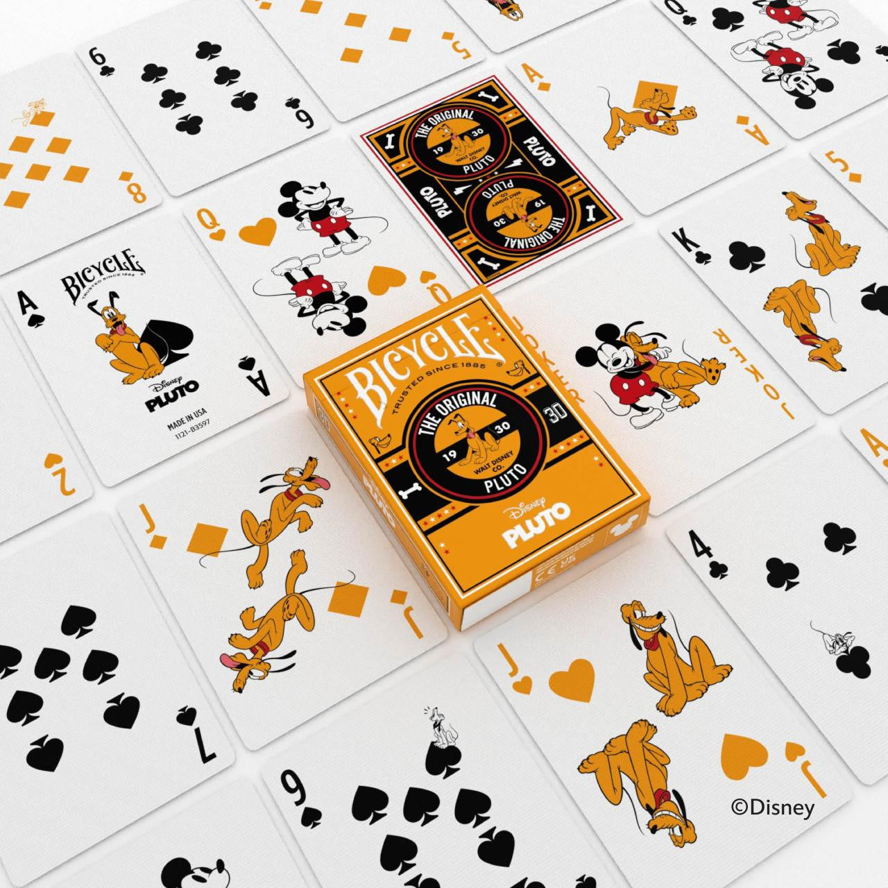 Bicycle Disney Pluto deck spread out showing Pluto and Mickey character cards with orange and black custom backs and tuck box in the center.