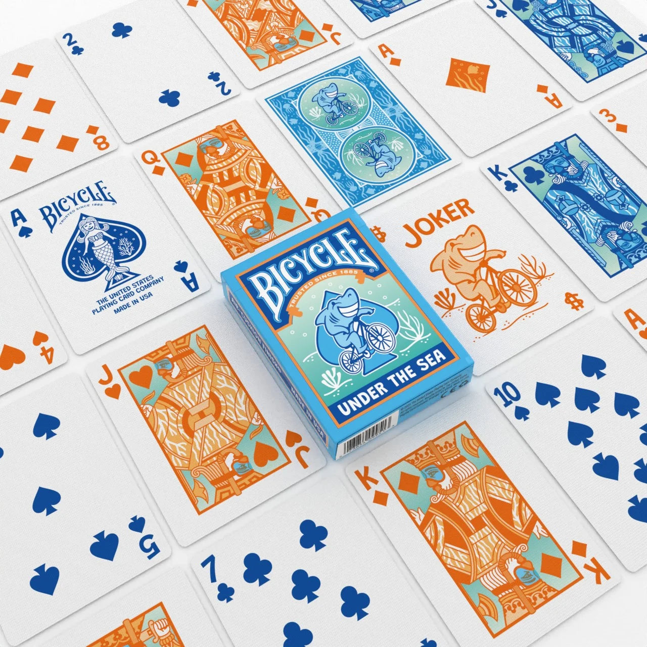Bicycle Under the Sea playing cards spread with custom shark Joker and ocean artwork