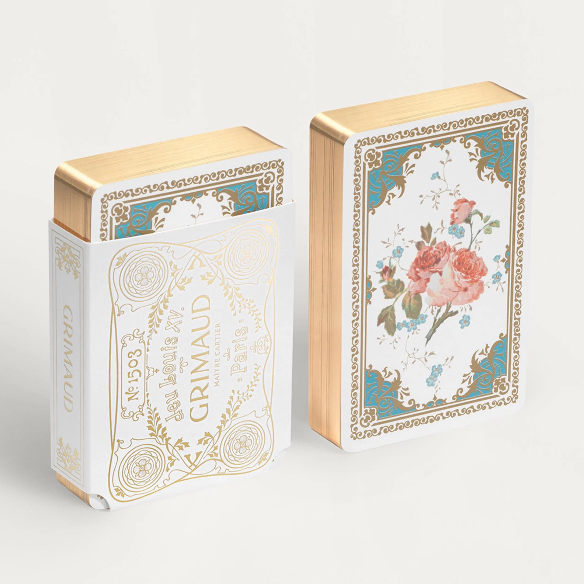 Two decorative Grimaud Jeu Louis XV boxes with floral designs and gold accents on a white background