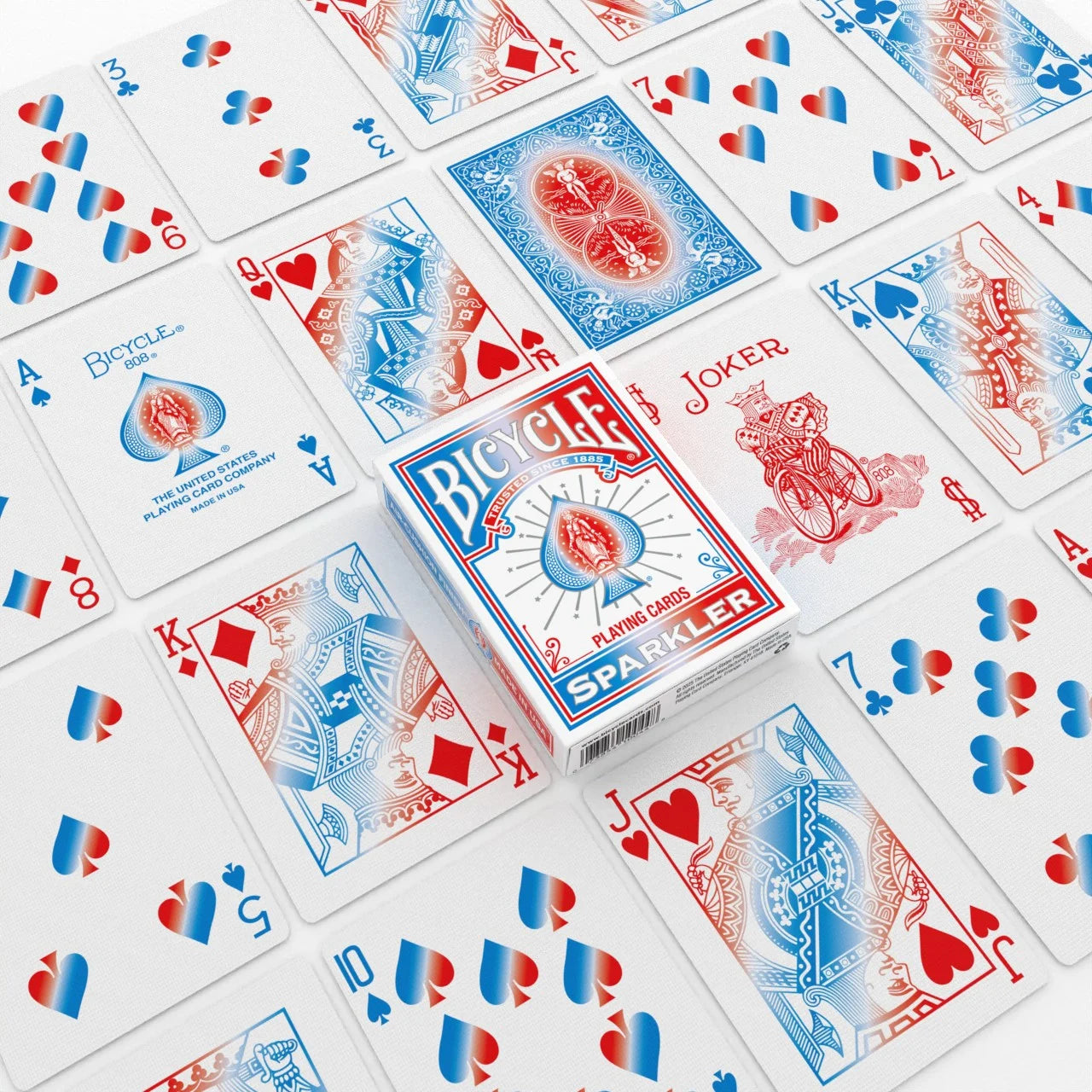 Bicycle Sparkler Playing Cards flat lay with white tuck box, Joker, custom courts, and red blue heart and spade pip cards