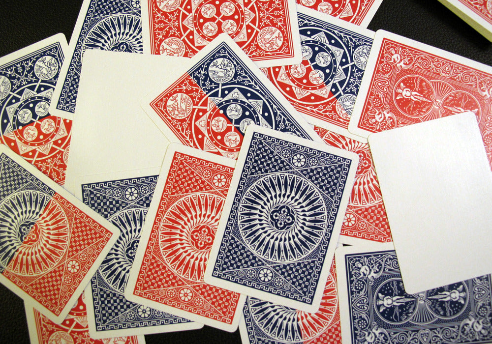 Playing cards with red and blue designs on a black surface