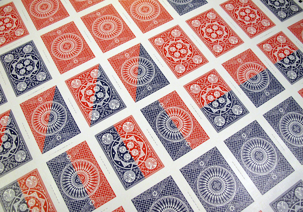 Patterned paper with red, blue, and gray geometric designs.