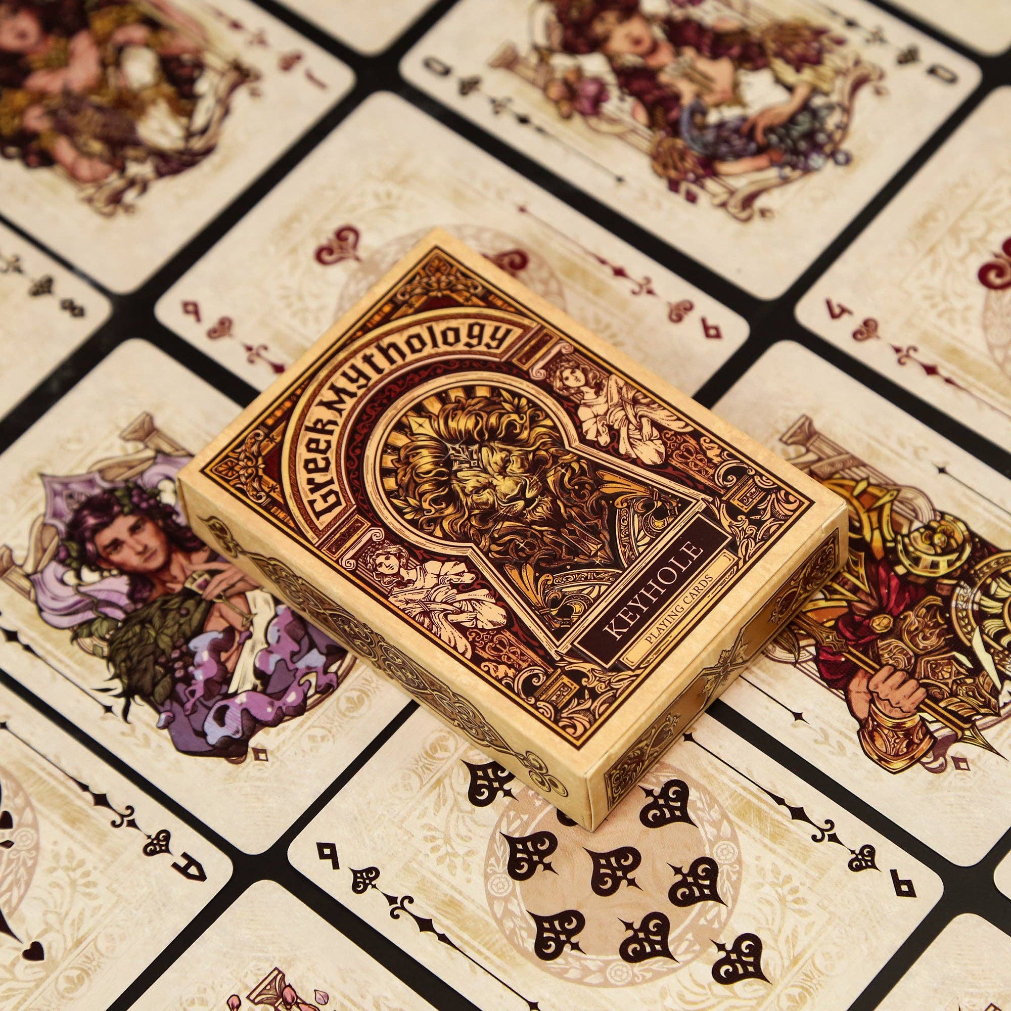 Playing card box labeled 'Greek Mythology' on a patterned card background
