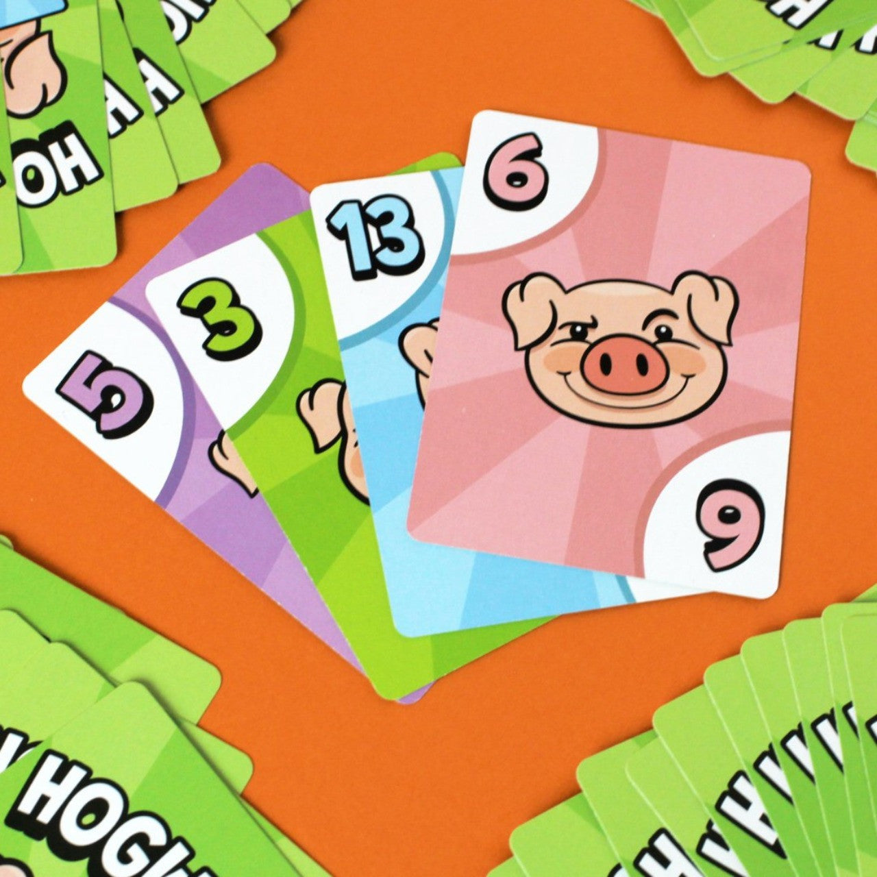 Colorful Bicycle Hogwash pig cards numbered 5, 3, 13 and 6
