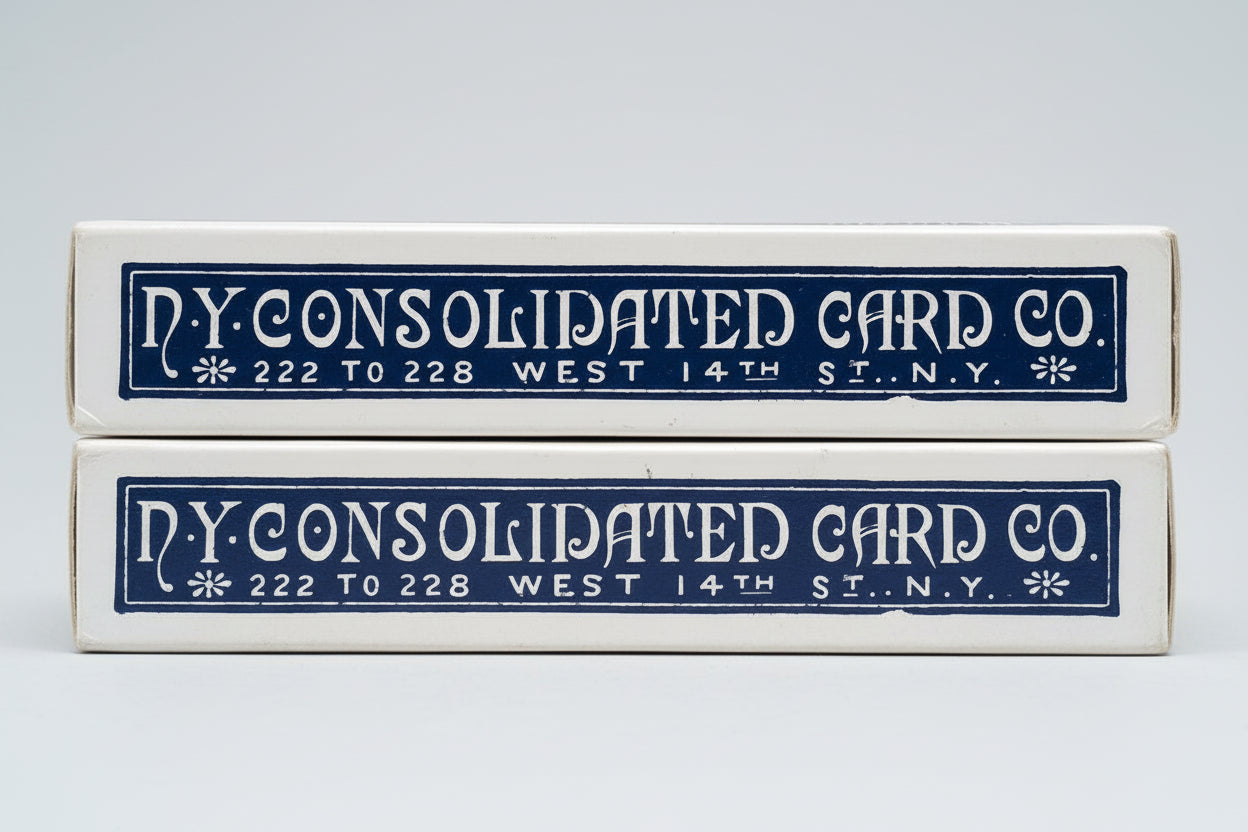 Two vintage boxes from N.Y. Consolidated Card Co. on a textured surface.