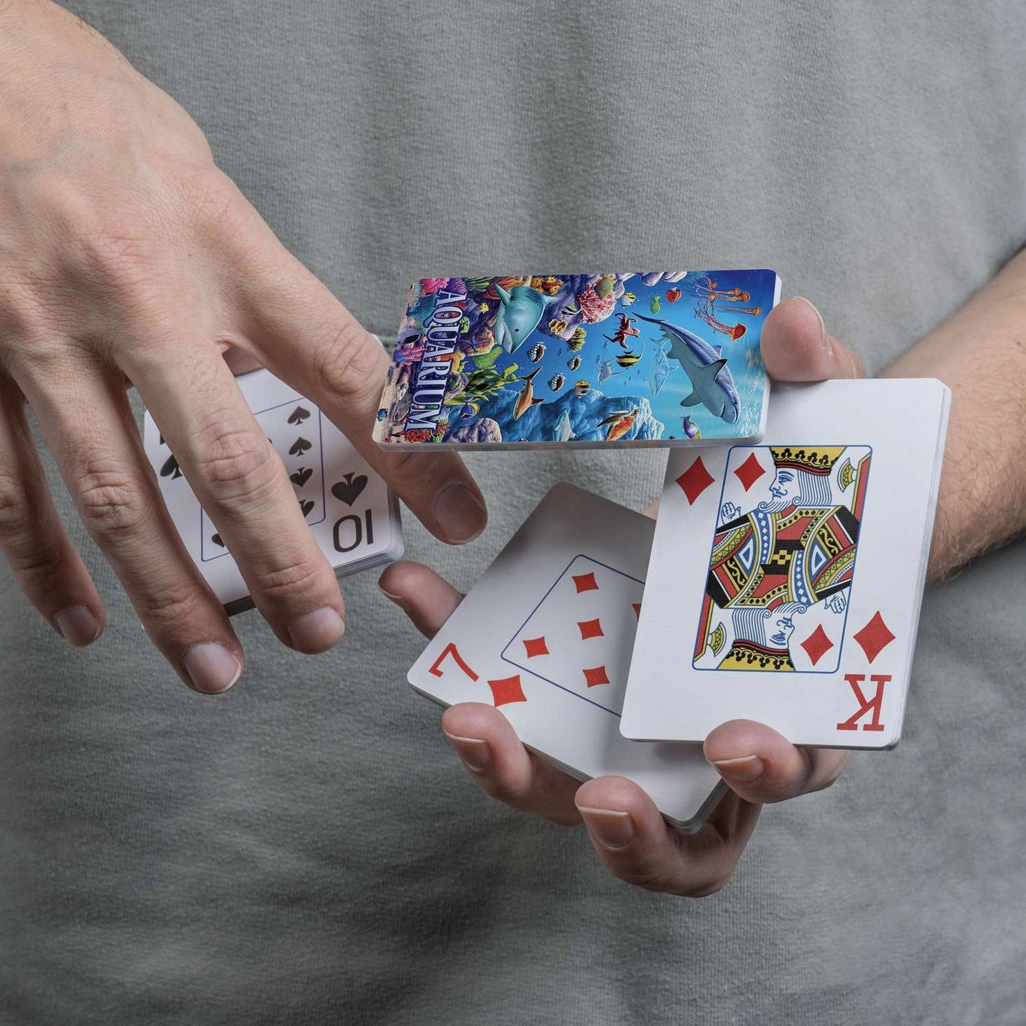 Close-up of Boardwalk Aquarium card back and traditional playing-card faces
