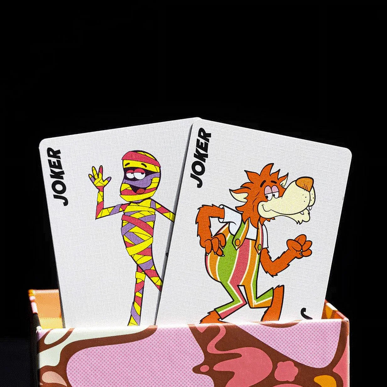 Two joker cards with cartoon characters on a colorful card holder against a black background
