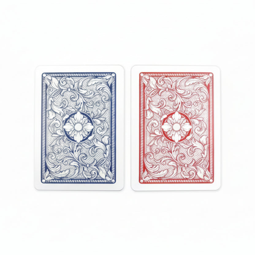 Two Copag Legacy 4‑Color 100% Plastic Playing Cards, one blue and one red, with decorative patterns on a white background.