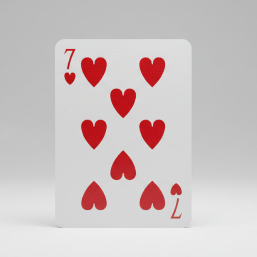 Card with the number 7 and red hearts on a white background