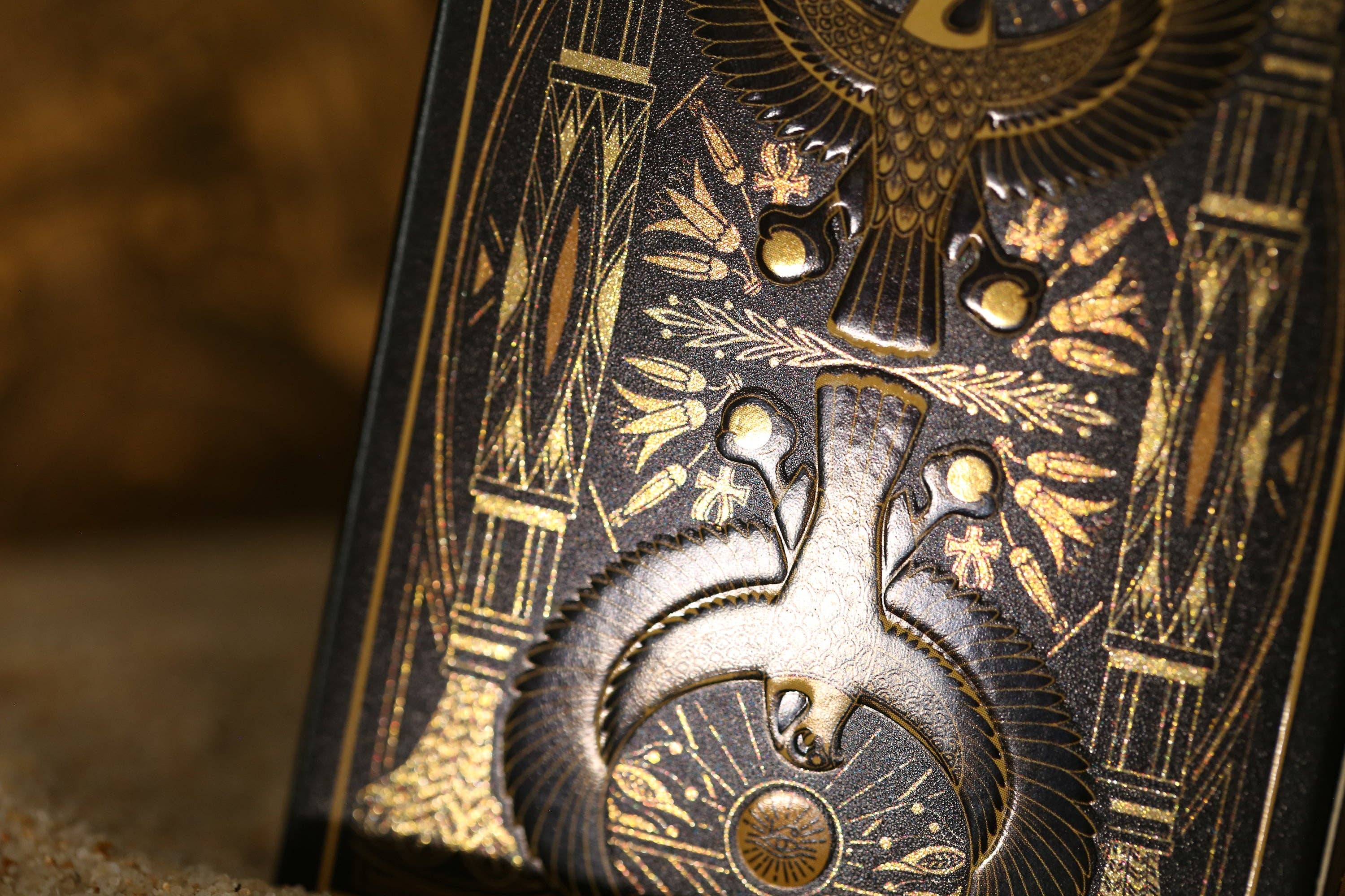 Close-up of a intricately designed object with gold patterns on a dark background
