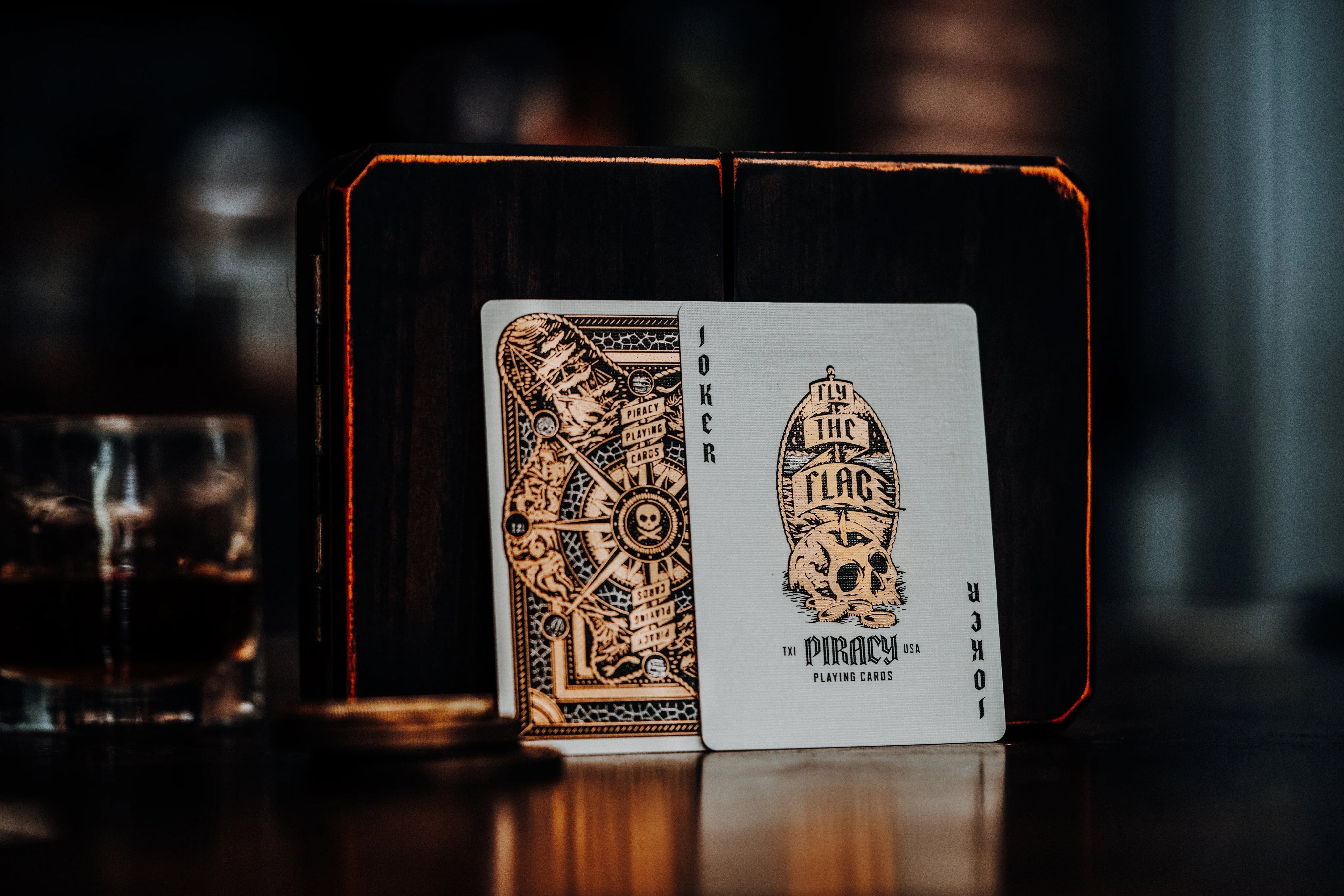 Piracy playing cards with intricate designs on a dark background