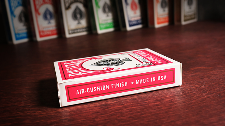 Playing card box with 'Air-Cushion Finish Made in USA' text on a wooden surface