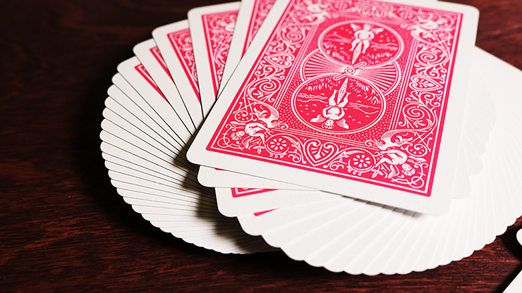Bicycle Fuchsia playing cards on a wooden surface
