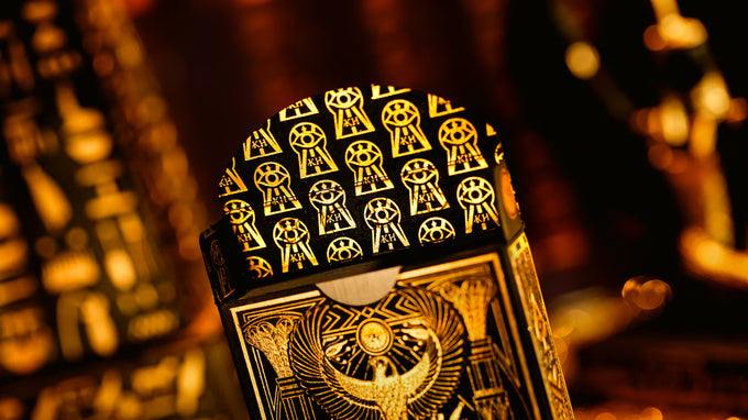 Close-up of a deck of cards with intricate designs on a blurred background