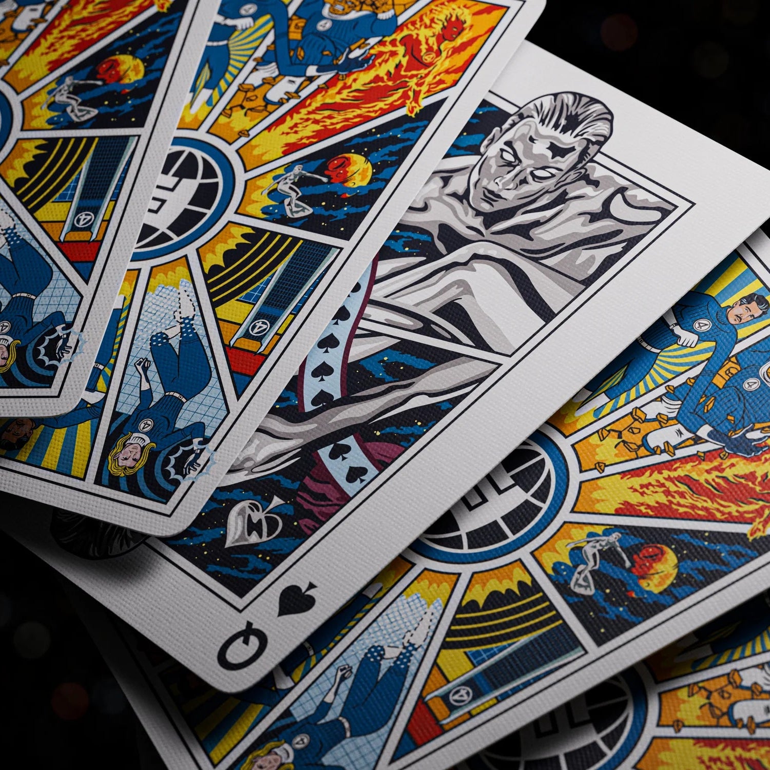 Colorful playing cards with intricate designs on a dark background