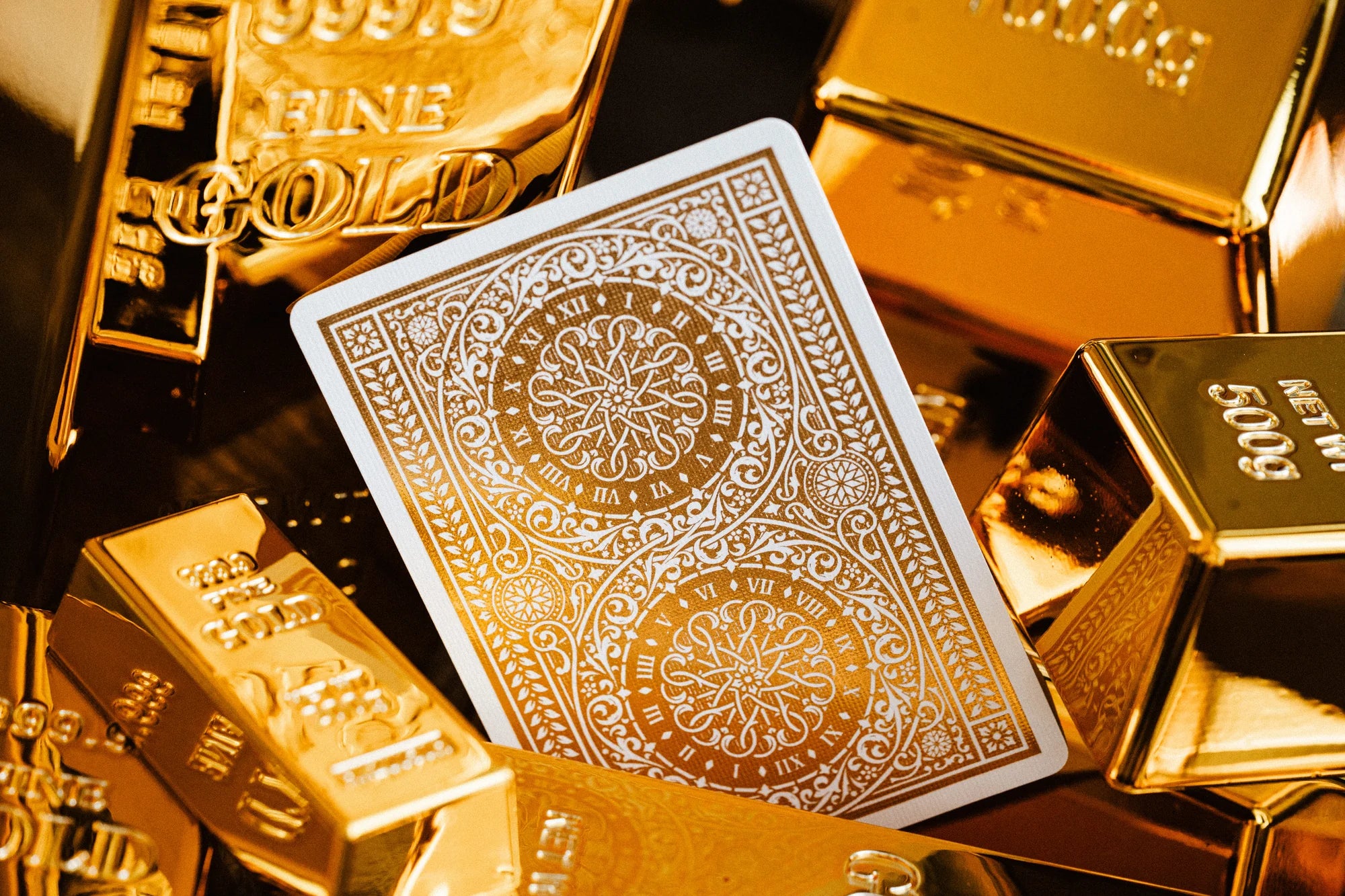 Gold-foiled Tycoon 25th Anniversary card back with clock and filigree design among gold bullion.