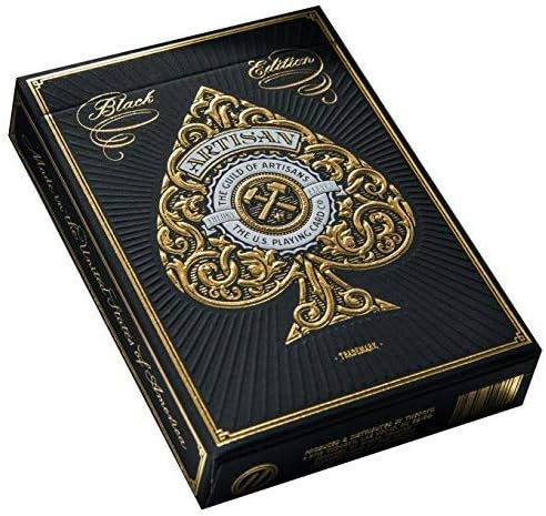 Black and gold playing card box with intricate design on a white background