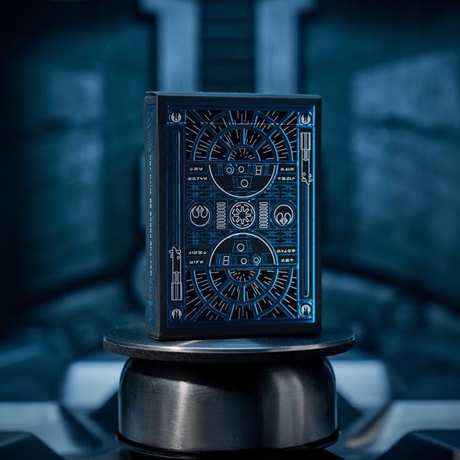 Black playing card box with intricate design on a dark background