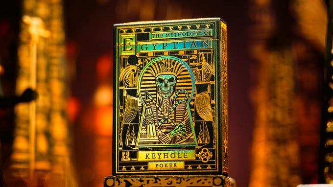 Gold Egyptian-themed poker keyhole with intricate designs on a blurred background