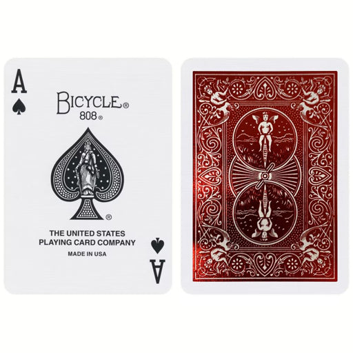 Two Crimson Metalluxe playing cards, one white and one red, with Bicycle branding on a white background.
