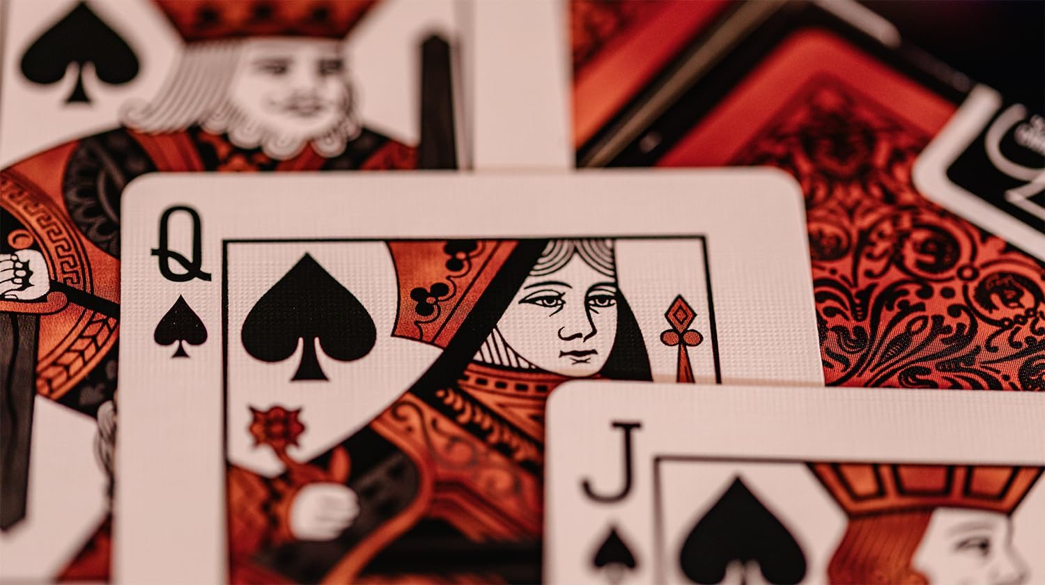 Close-up of playing cards with Queen of Spades and Jack of Hearts