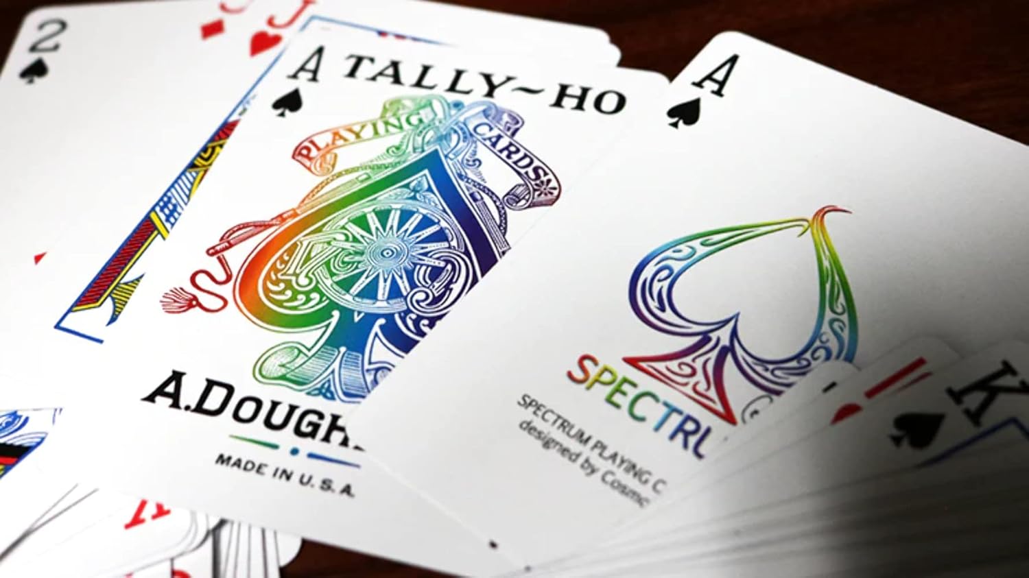 Playing cards with 'Spectrum' and 'A.Dougherty' branding on a wooden surface