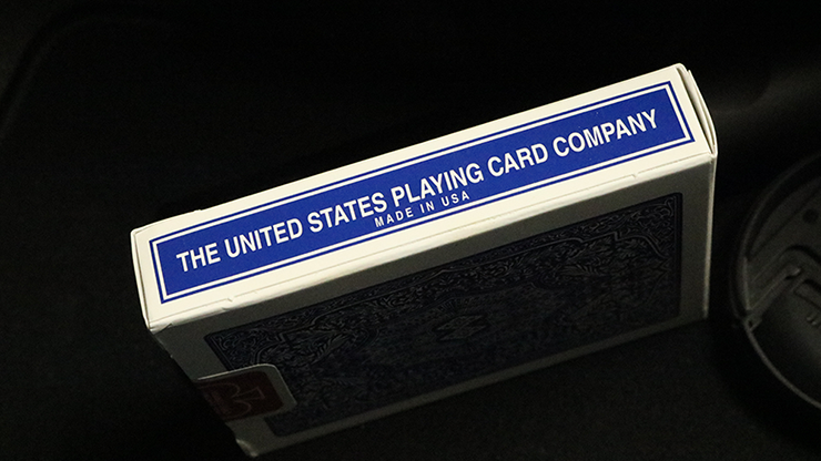 Card deck with 'The United States Playing Card Company' label on a dark background