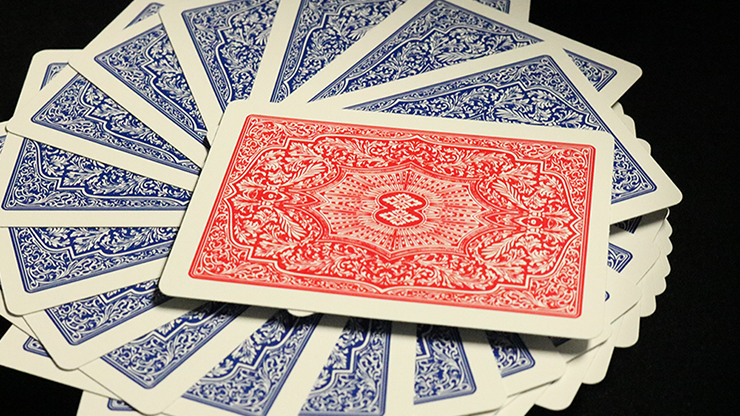 Playing cards fanned out with a red back card on a black background