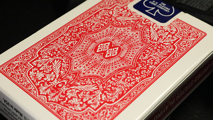 Red and white playing card box with intricate design and 'Piatnik' branding.