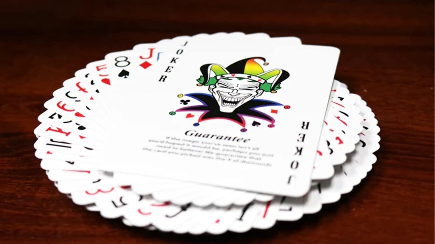 Tally Ho Spectrum playing cards with Joker card on a wooden surface