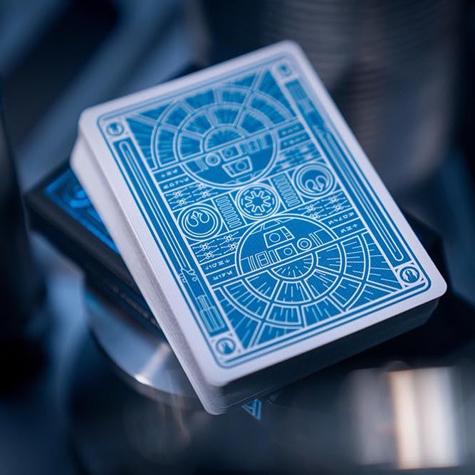 Blue playing cards with intricate designs on a reflective surface