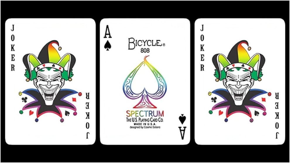 Three Bicycle Spectrum playing cards featuring a joker, ace of spades, and another joker on a black background.
