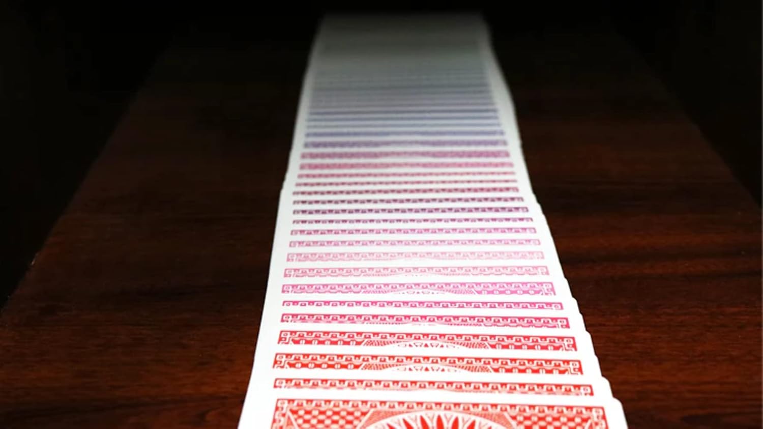 Stack of Tally Ho Spectrum playing cards on a wooden surface