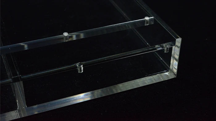Close-up of Carat X4x3 clear acrylic case showing magnetic closure and internal dividers