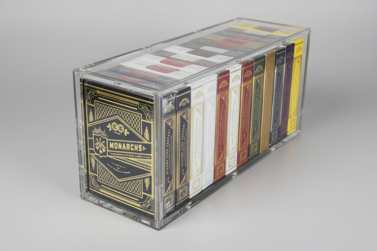 Angled view of Carat X12 acrylic case holding a full brick of 12 Theory11 Monarch playing card decks