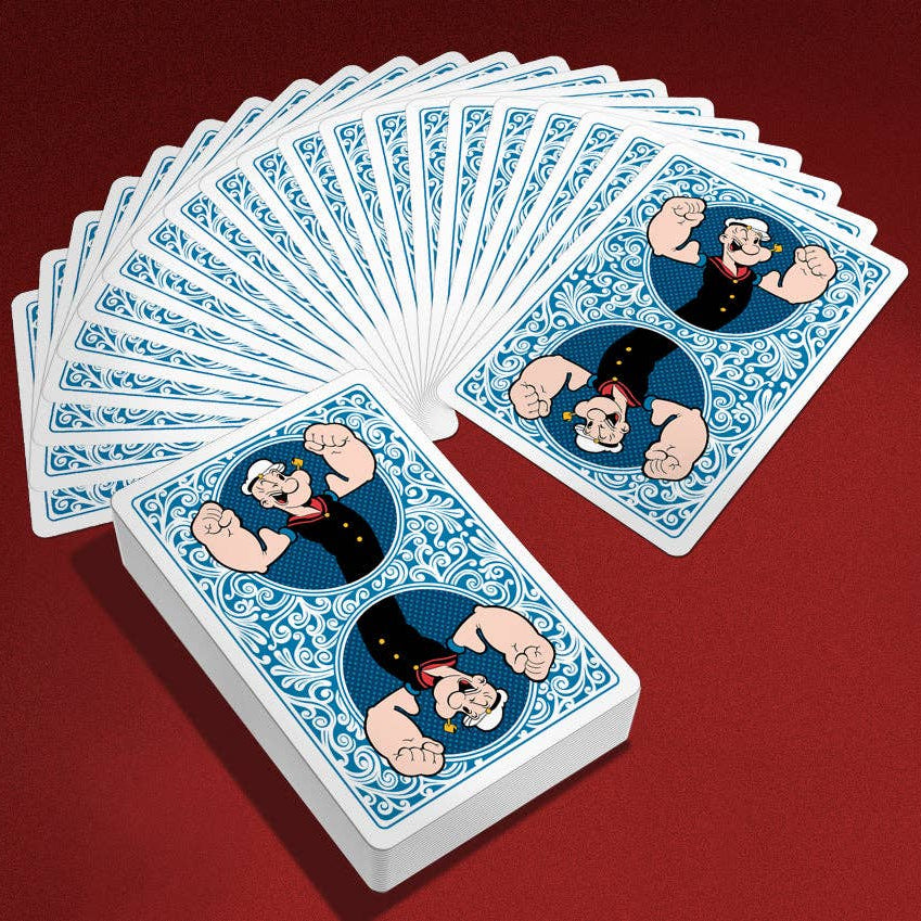 Playing cards with Popeye design on a red background