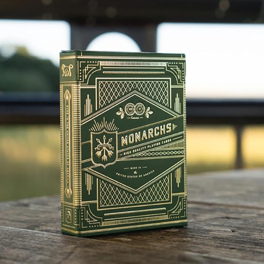Green deck of cards with 'Monarchs' branding on a wooden surface