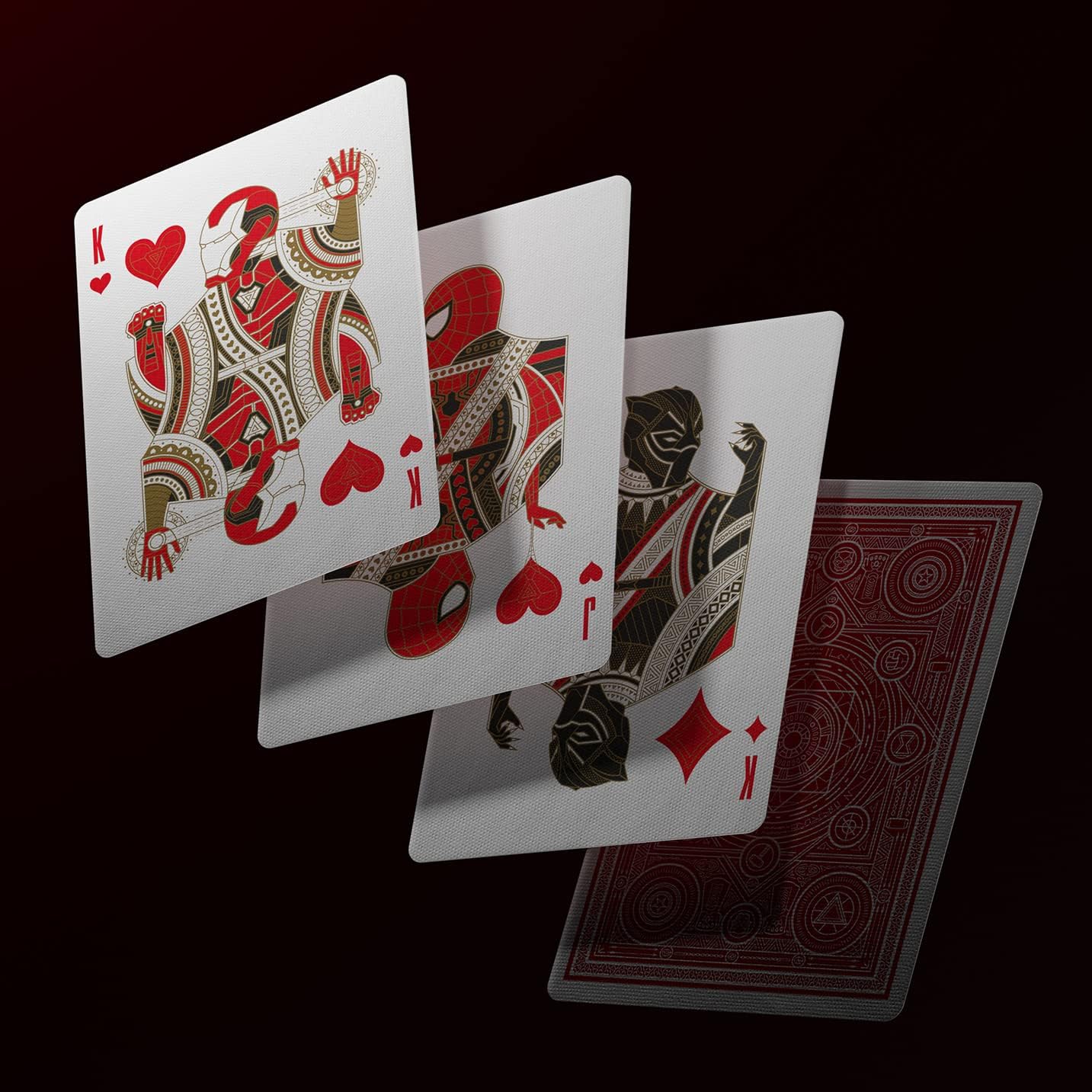 Three playing cards with King of Hearts design on a black background