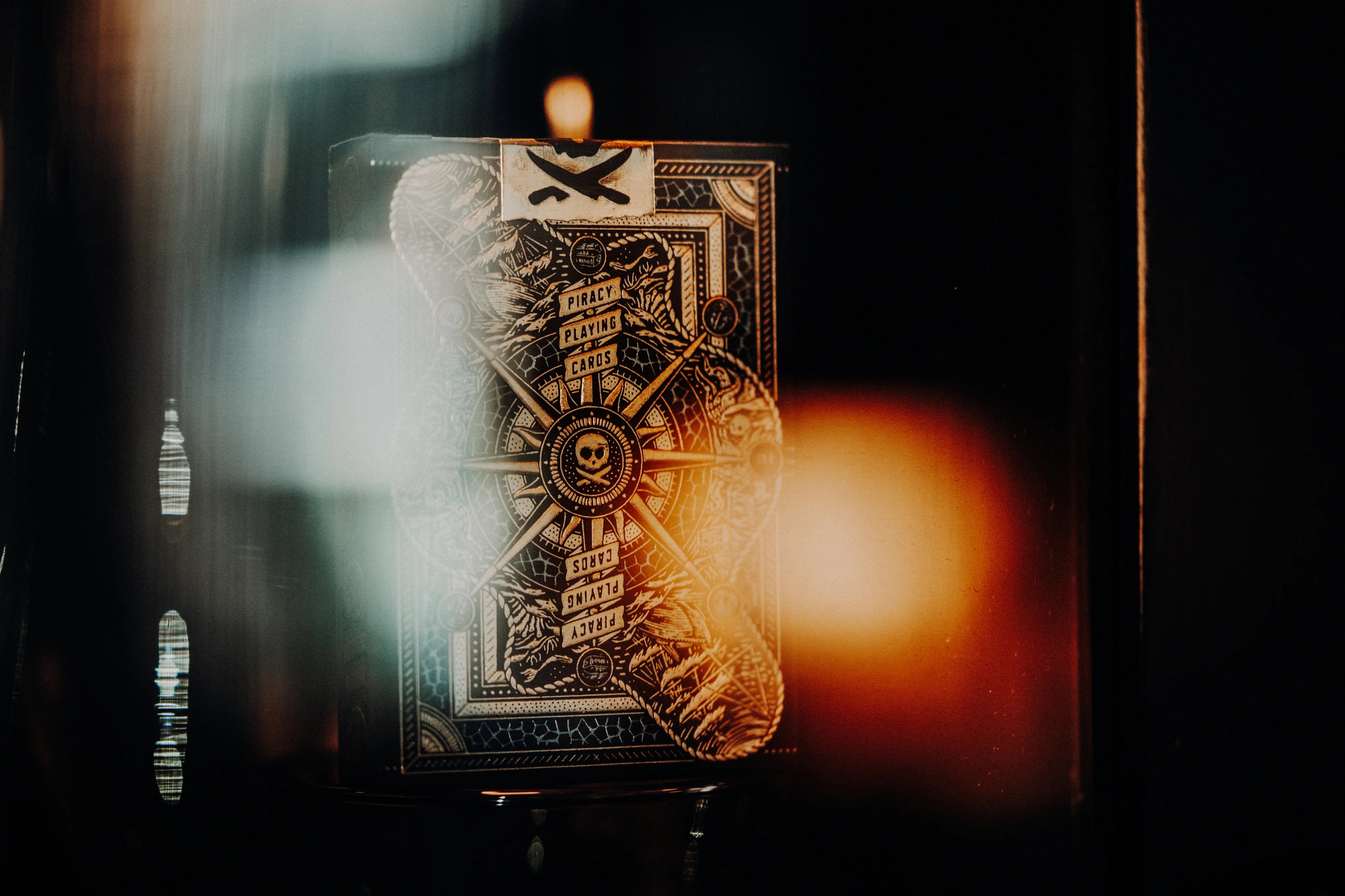 Close-up of a Piracy playing card with intricate design on a dark background